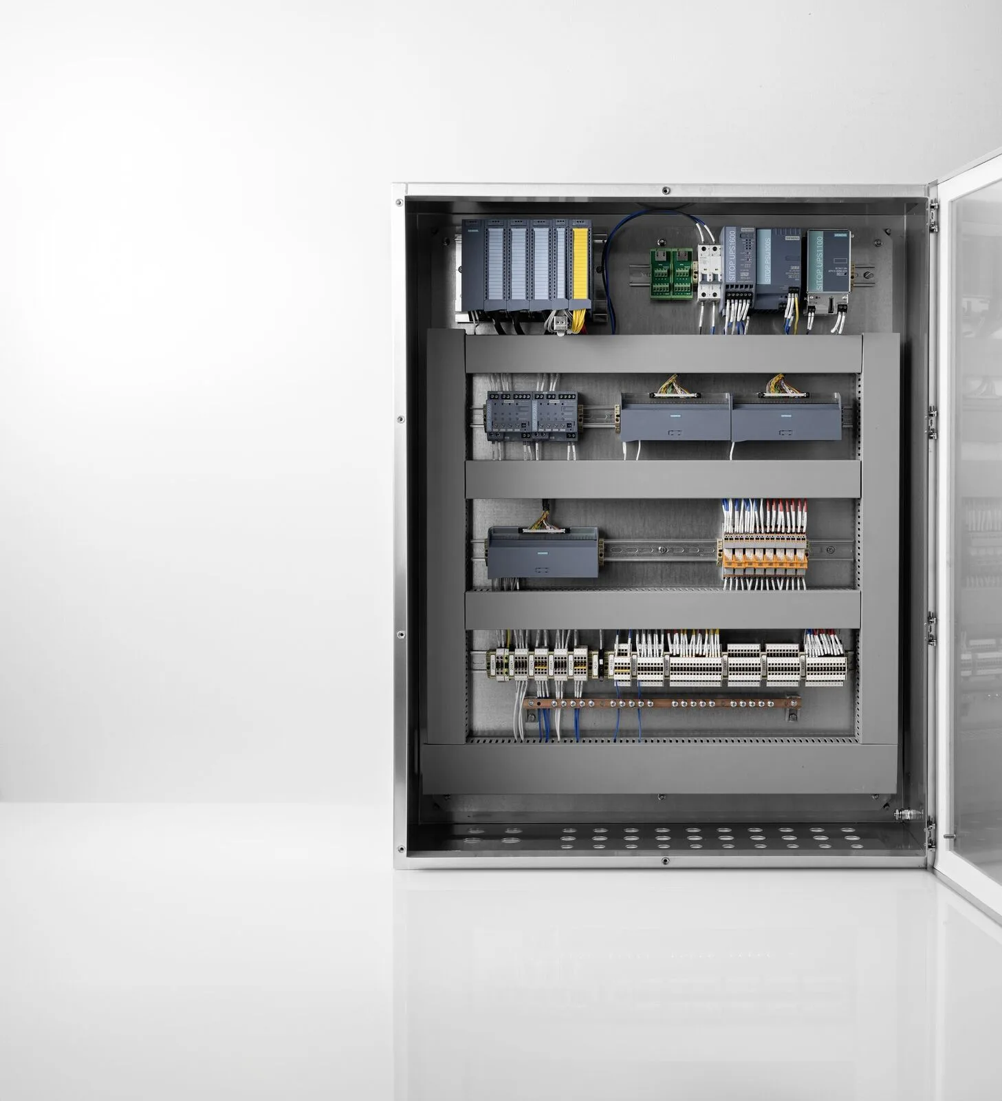 Wired panel interior · DIN rail · labelled terminal blocks · ready to install